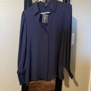 Polyester Navy blue long sleeve blouse. Never worn, still with tags.